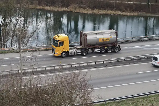Container haulage trailer on a highway between factory and port